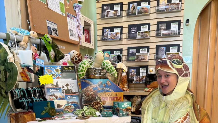 Woman dressed as turtle in CROW gift shop