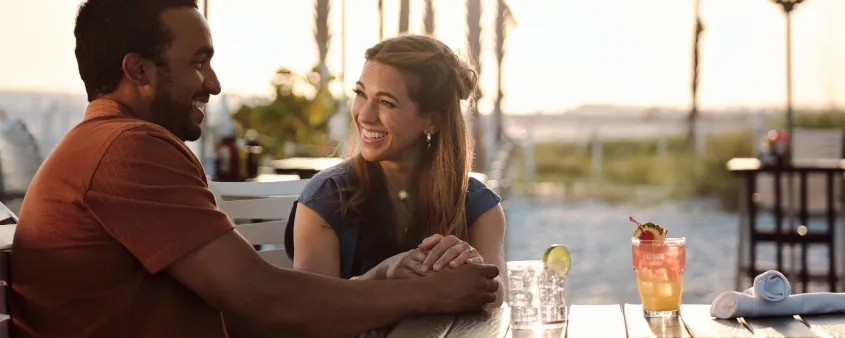 A couple enjoys dinner on the beach