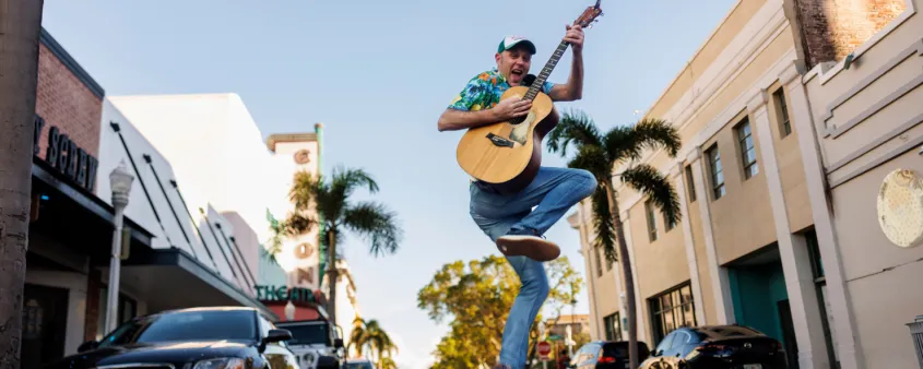 A songwriter hops in the air